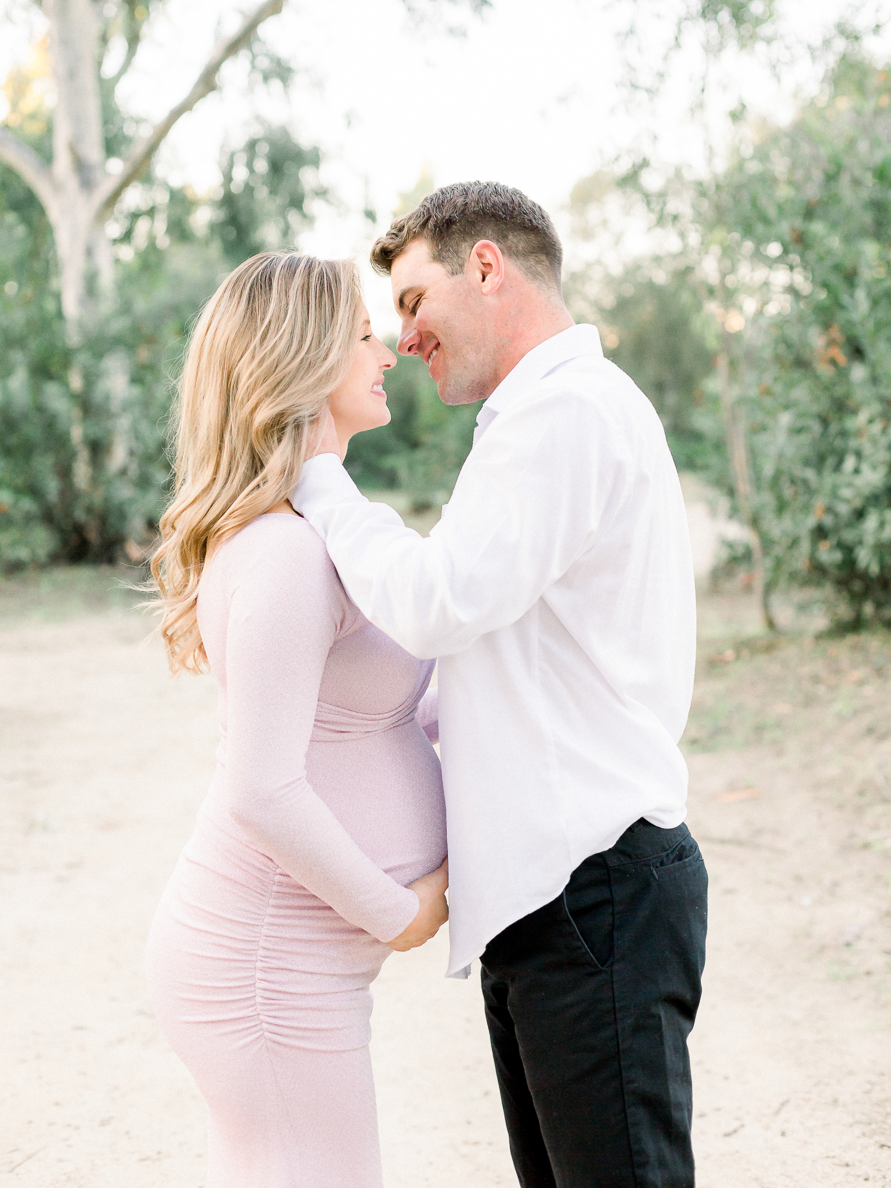 Couple almost kissing during their maternity session