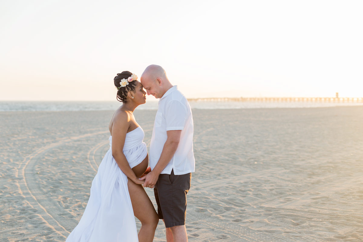 pregnant couple in Seal Beach at sunset