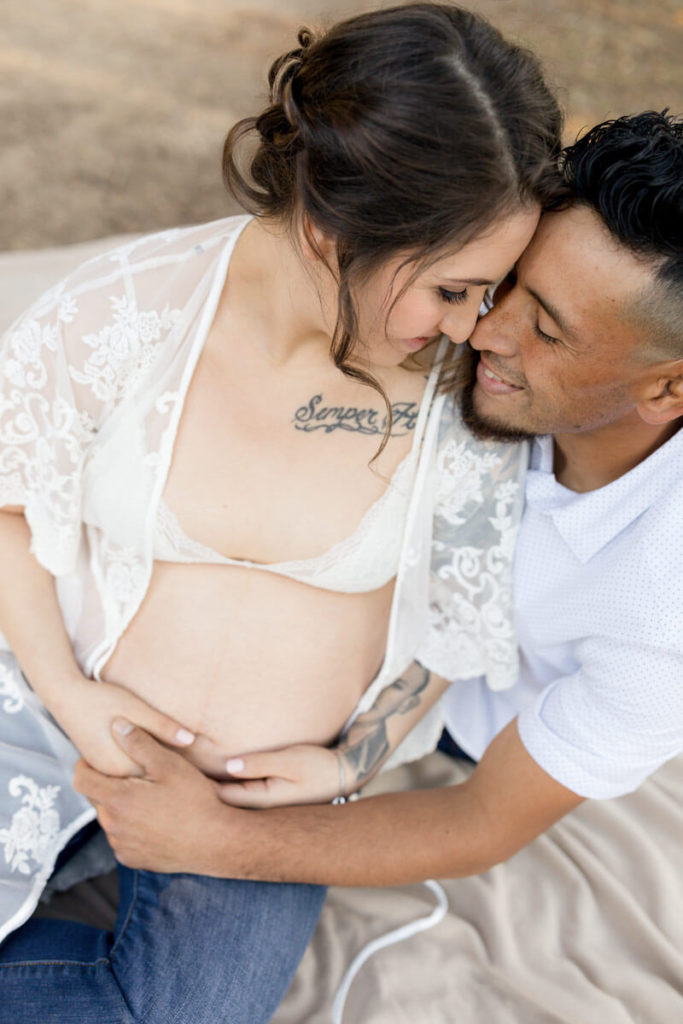 Pregnant couple posed for maternity photos
