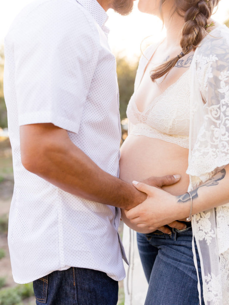 Pregnant couple posed for maternity photos