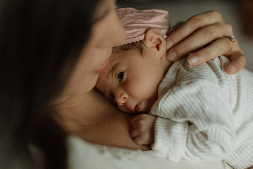 Close-up of baby on mama’s chest, eye contact
